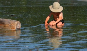 The innocent joy of childhood. A pool, a sunny day, and a piece of wood that morphs into a boat